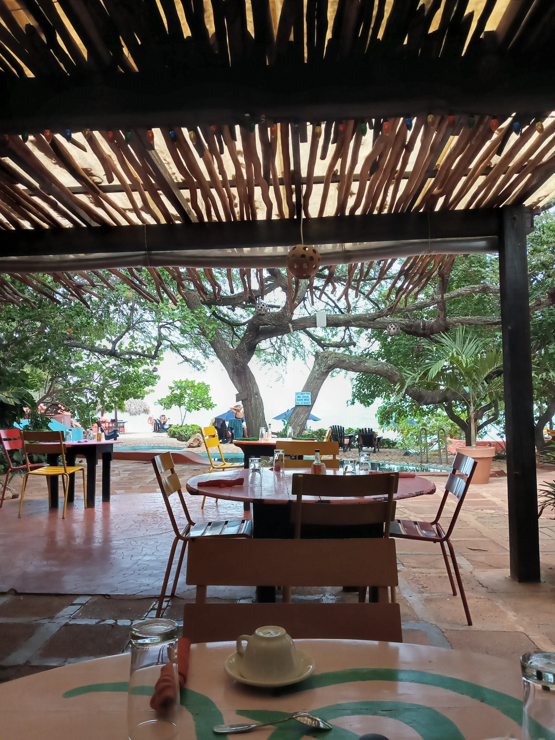 A cozy outdoor seating area with comfortable furniture, perfect for enjoying the beach breeze.