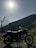 A close-up of a motorcycle parked on a scenic road.