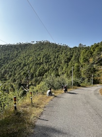 Smiling rider taking a break on a forest trail, enjoying the view.