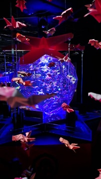 A vibrant marketing campaign visual with dynamic typography and origami-inspired shapes.