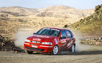 Dynamic shot of Team 988's rally car kicking up dust on a rugged American trail.
