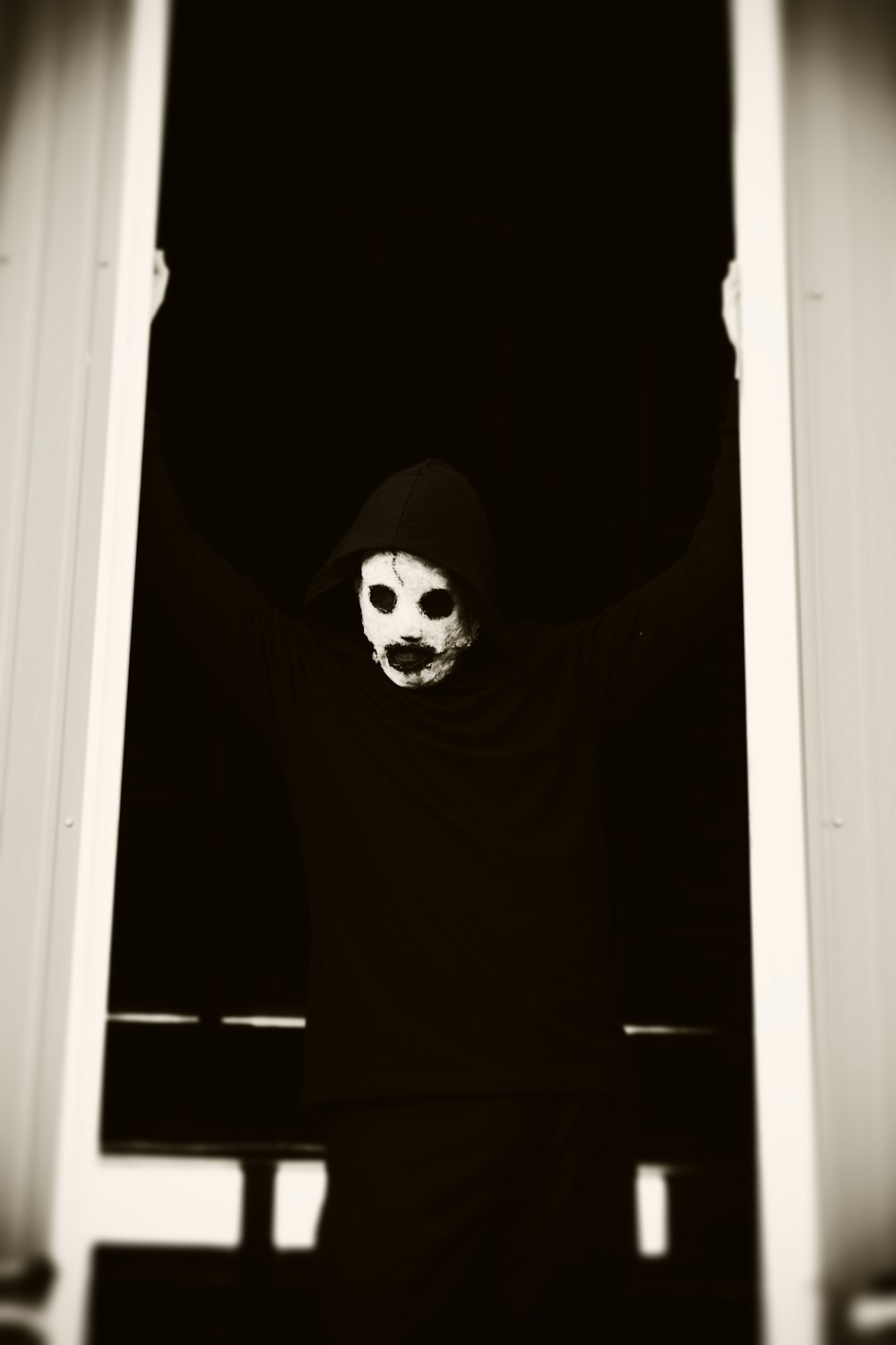 a person wearing a mask standing in a doorway
