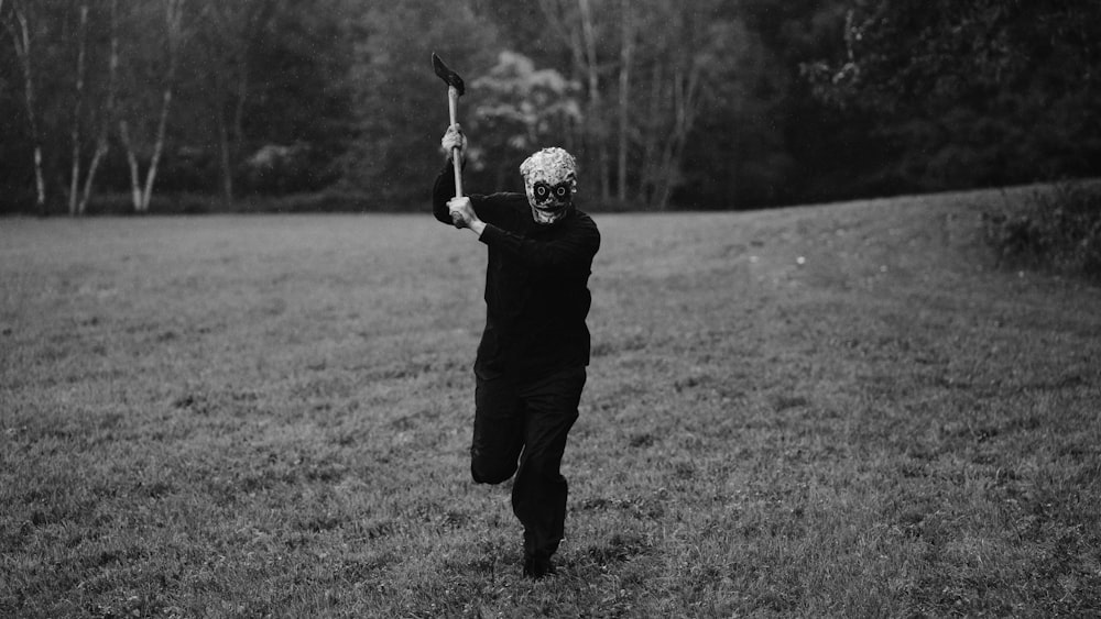 a person running through a field with a bird on their arm