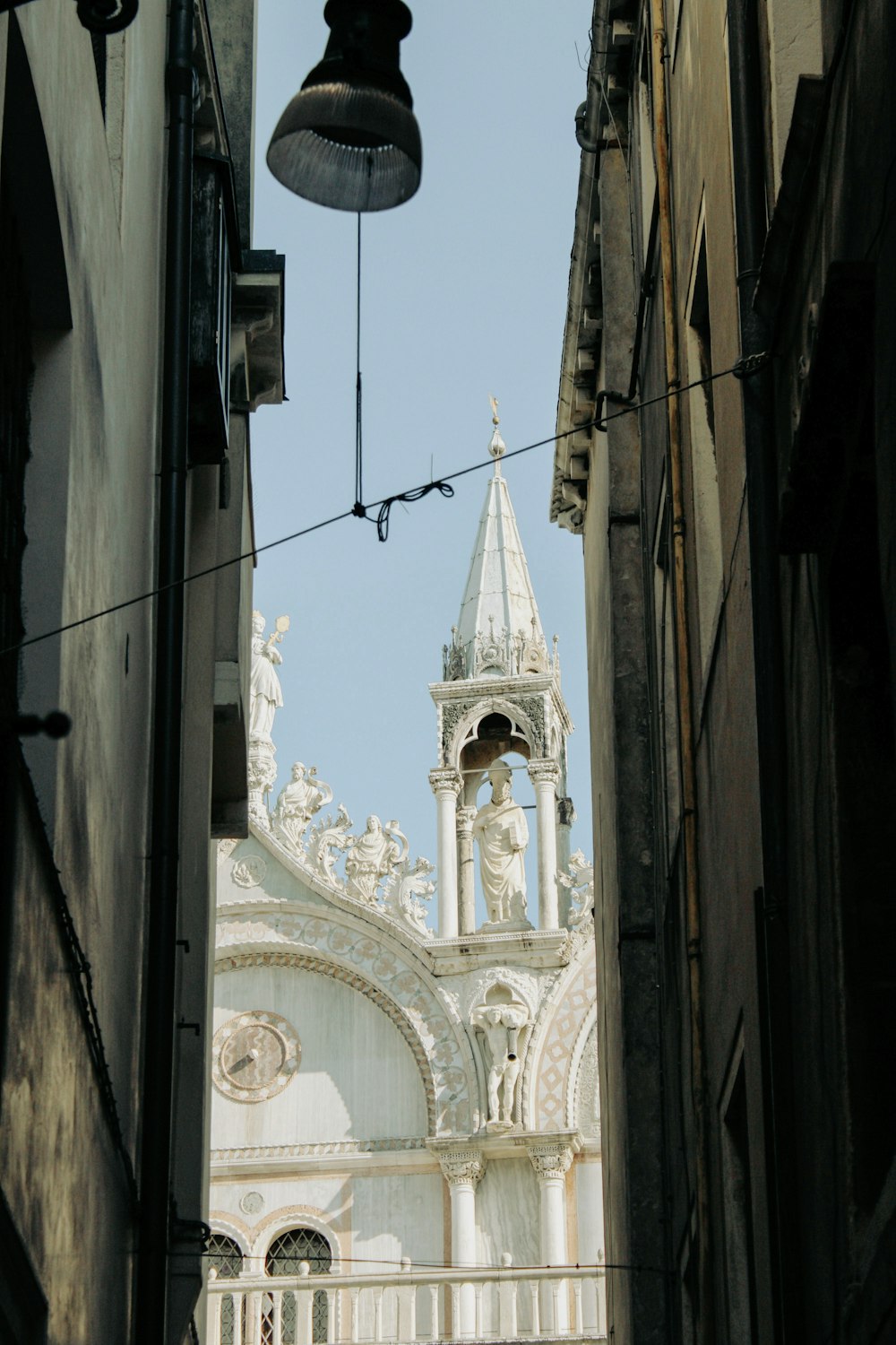 a view of a church through a narrow alley way