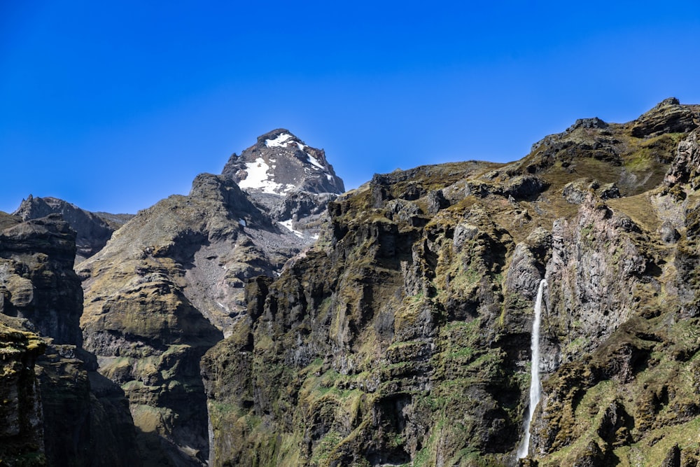 a mountain with a waterfall in the middle of it