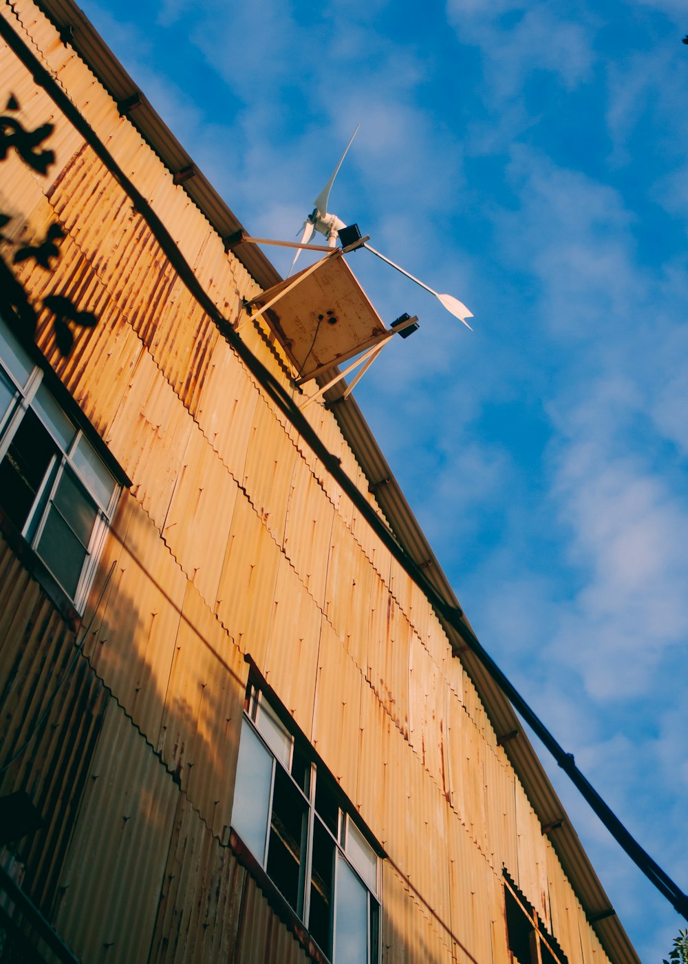 a wind turbine on top of a wooden building