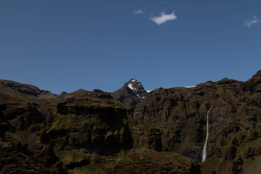 a mountain with a waterfall in the middle of it