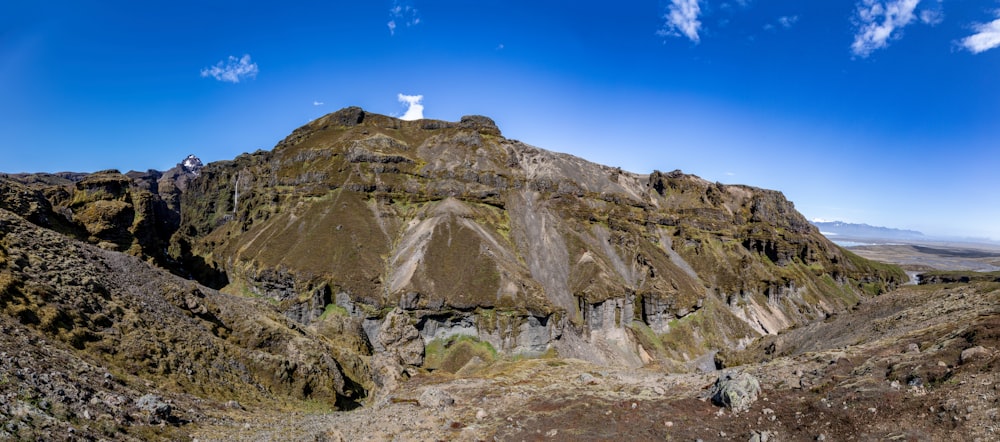 a large mountain with a cross on top of it