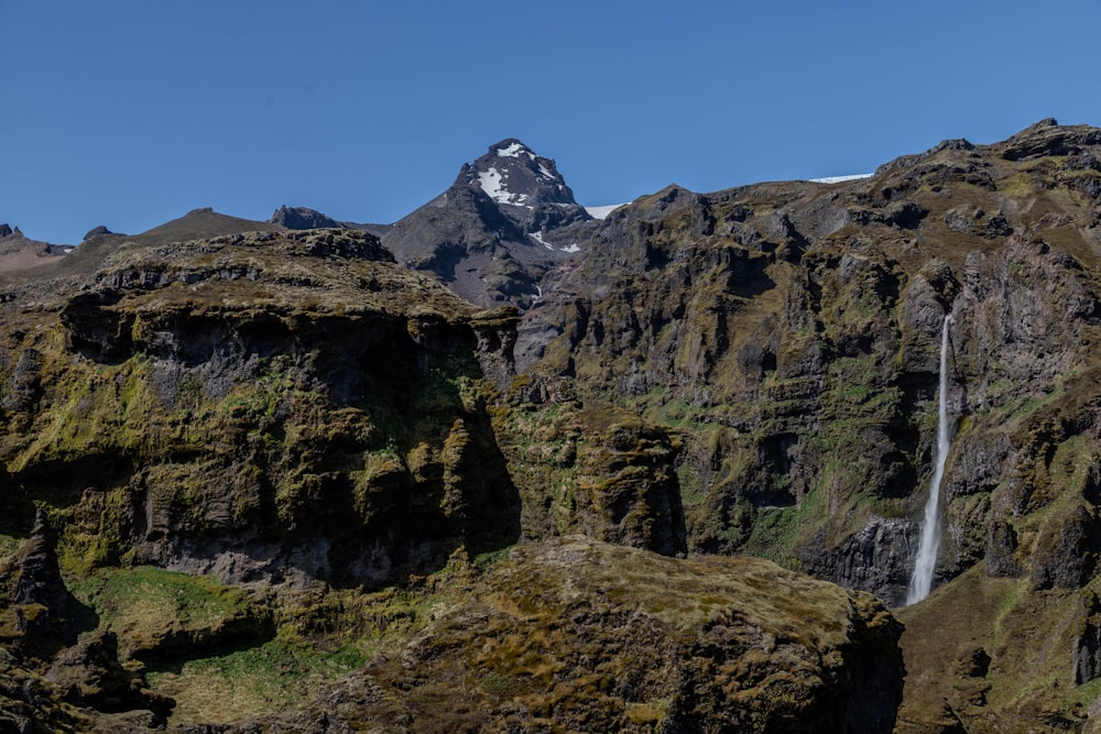 a mountain with a waterfall in the middle of it