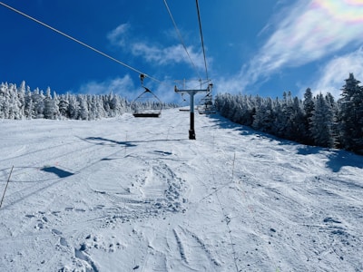 Ski lift ascending above untouched snow under a winter sky