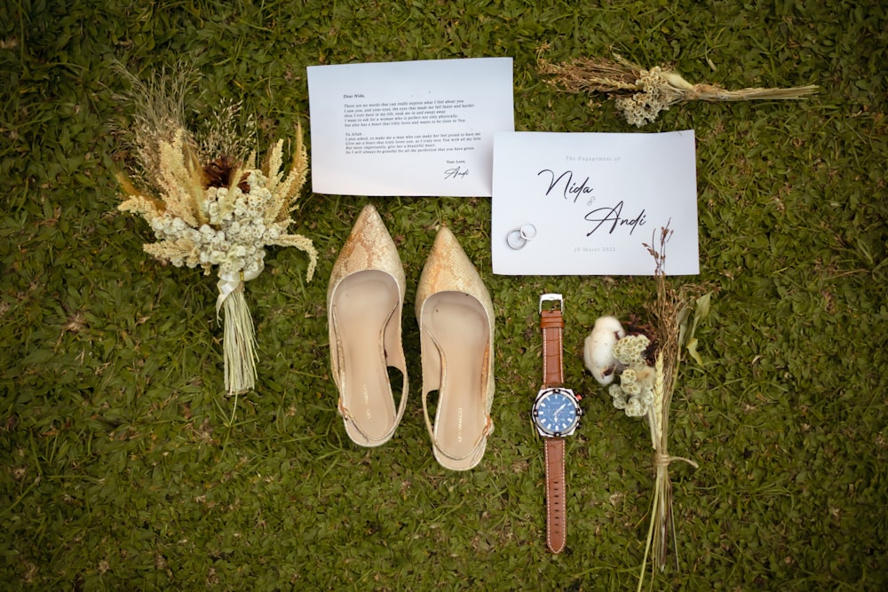 a couple of shoes and some flowers on the ground