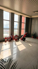 Bright, spotless hospital corridor with sunlight streaming through large windows.