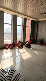Housekeeping staff cleaning a bright, tidy common area with natural light.