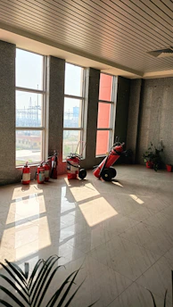 Bright, spotless hospital corridor with sunlight streaming through large windows.