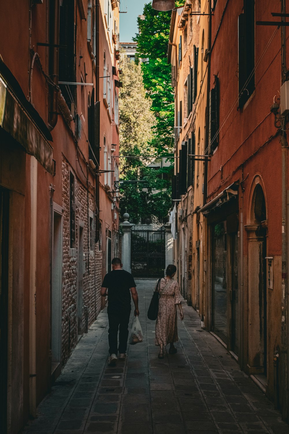 a couple of people that are walking down a street