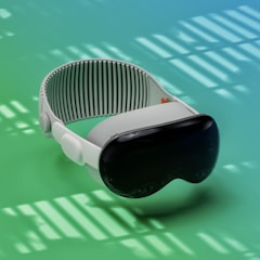 A sleek virtual reality headset with a dark visor and adjustable white strap is placed against a gradient background of green and blue shades. The lighting creates patterns of shadows and highlights that add a dynamic effect.