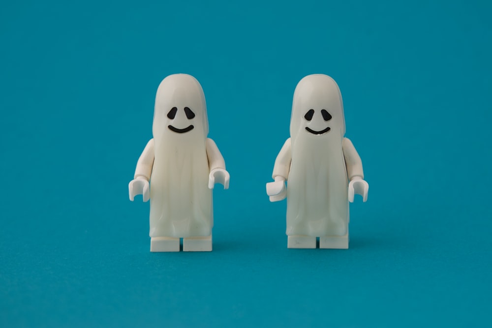 a couple of lego figures standing next to each other