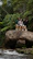 Group of friends laughing together on a scenic Malaysian hilltop.