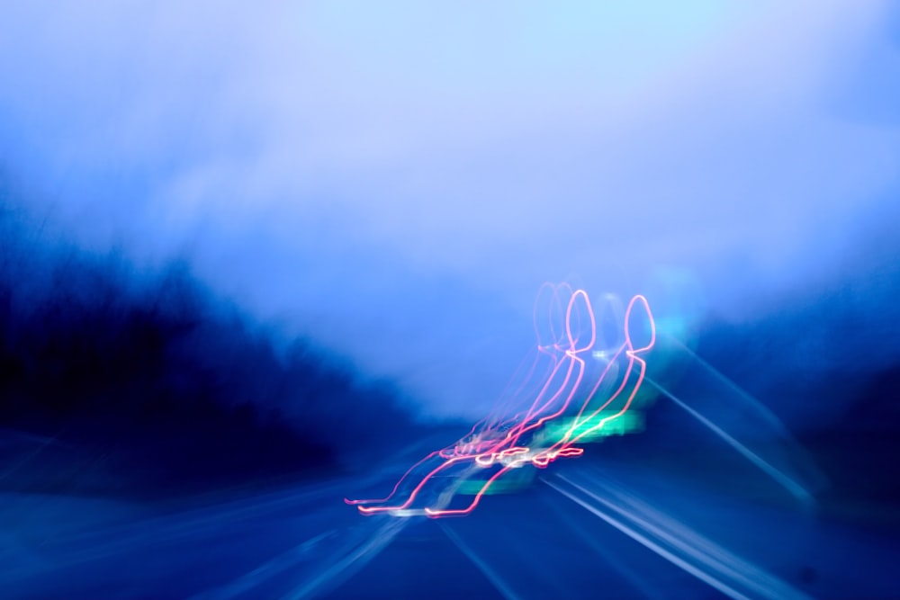 a blurry photo of a car driving down a highway