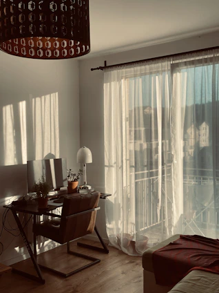 A warm, inviting home office with soft lighting and calming decor, symbolizing a safe space for online therapy sessions.