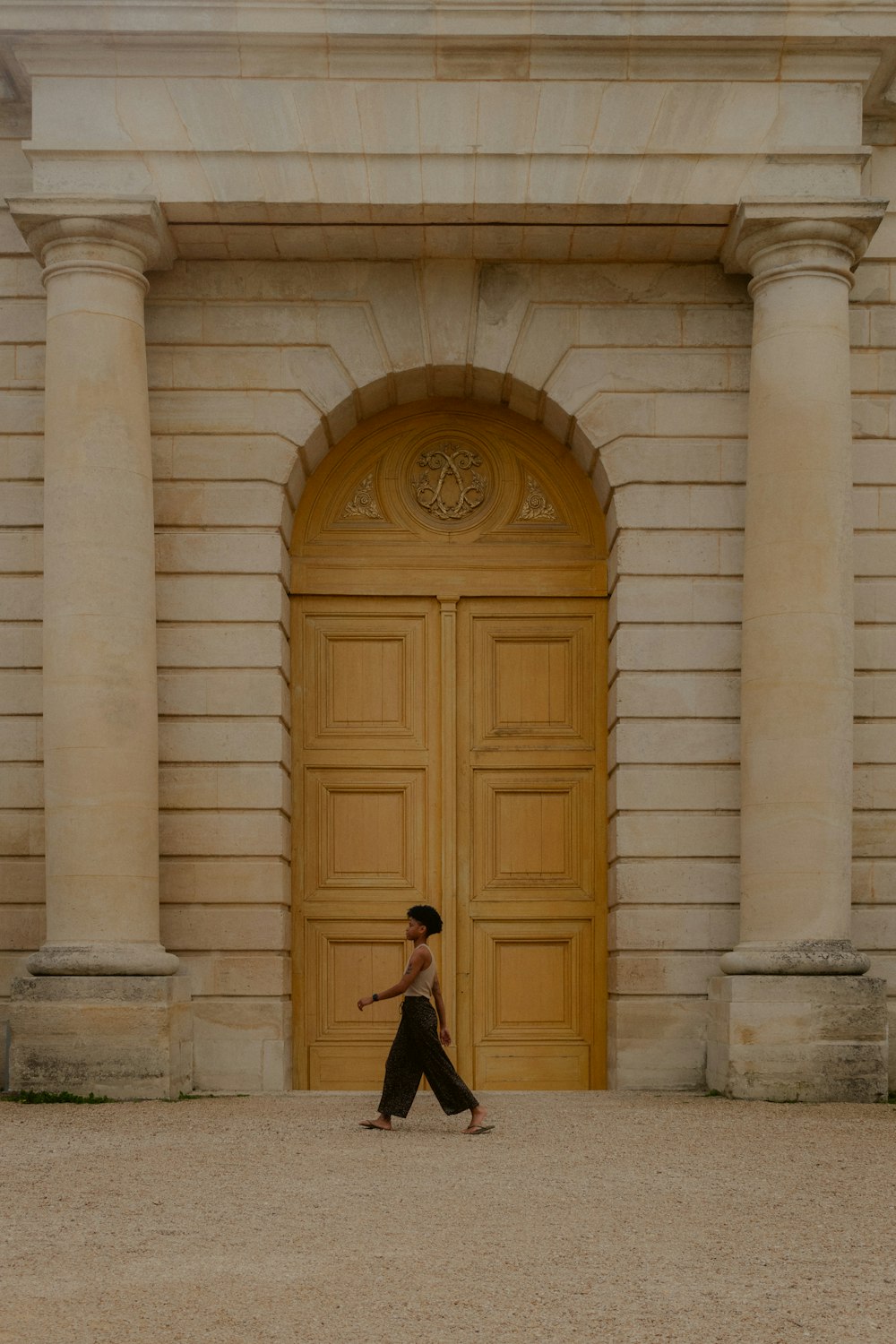 a person walking in front of a large wooden door