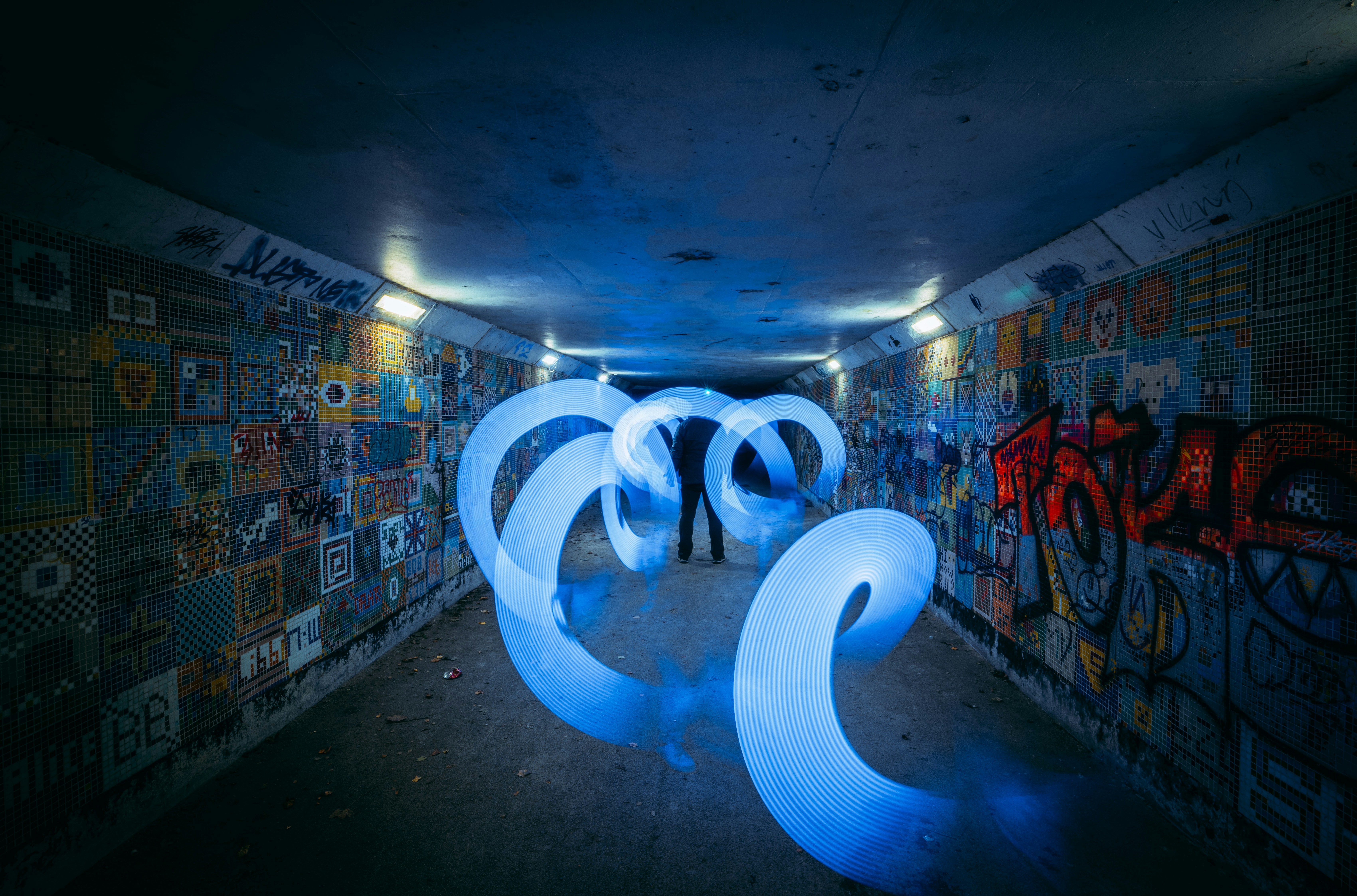 a couple of people standing in a room with graffiti on the walls