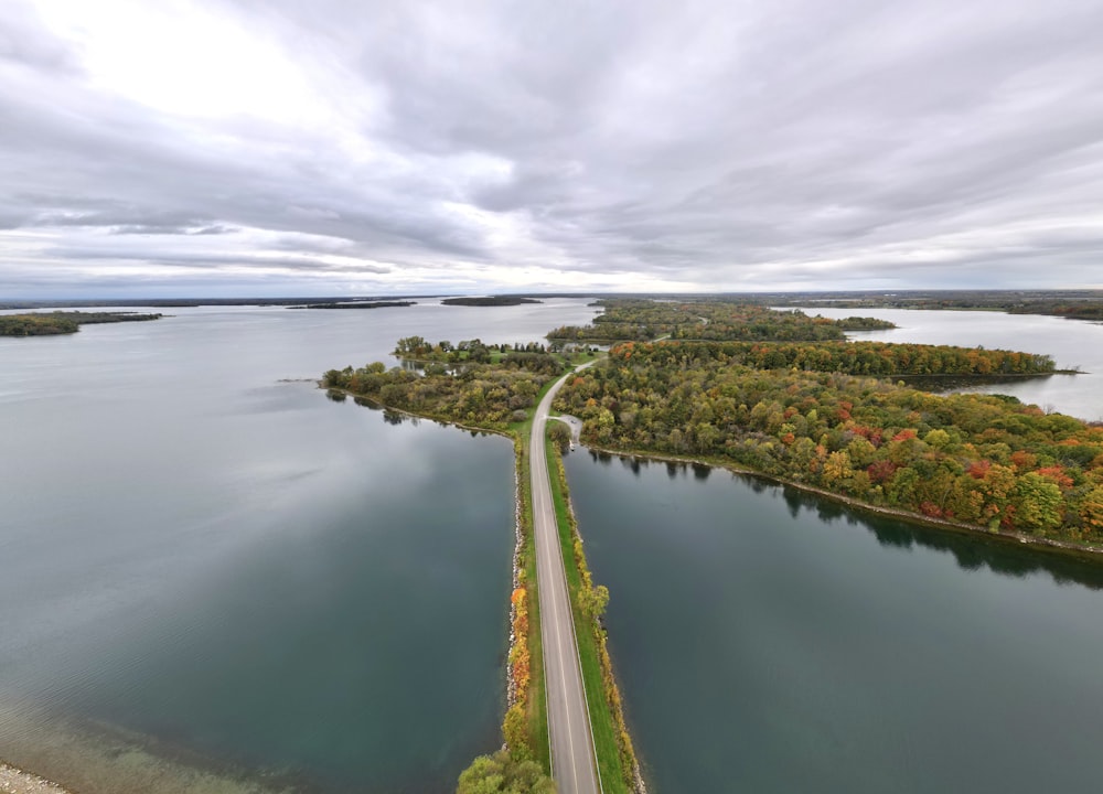 an aerial view of a road near a body of water