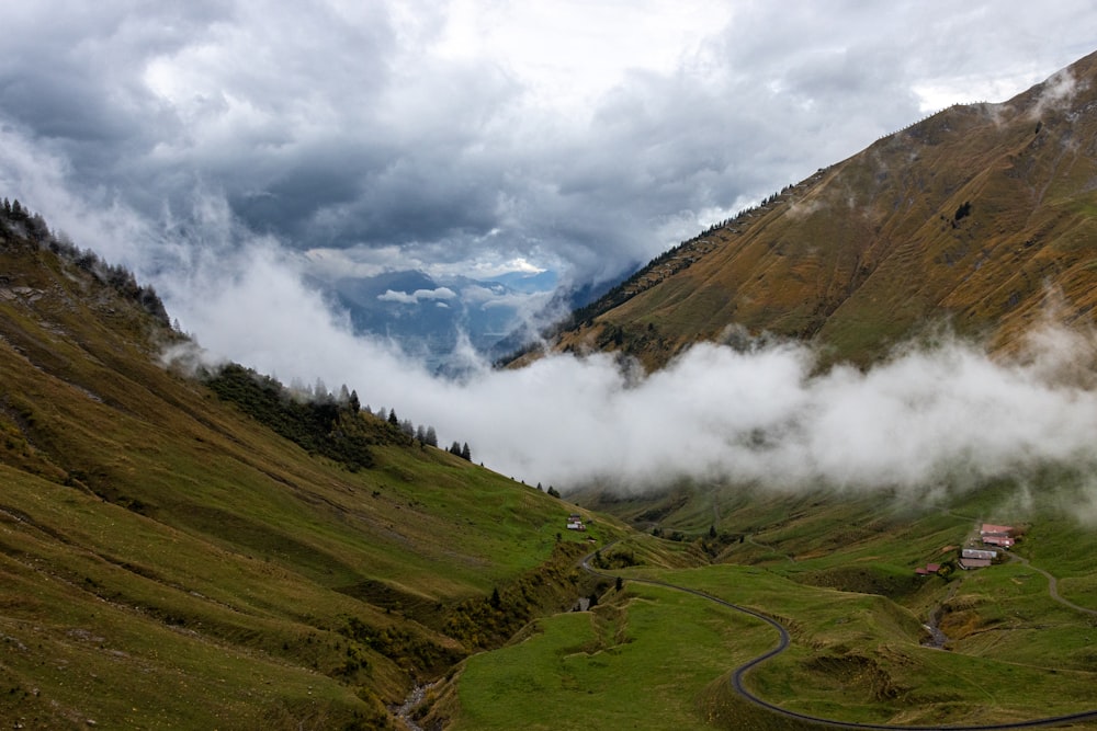 a scenic view of a valley with a winding road