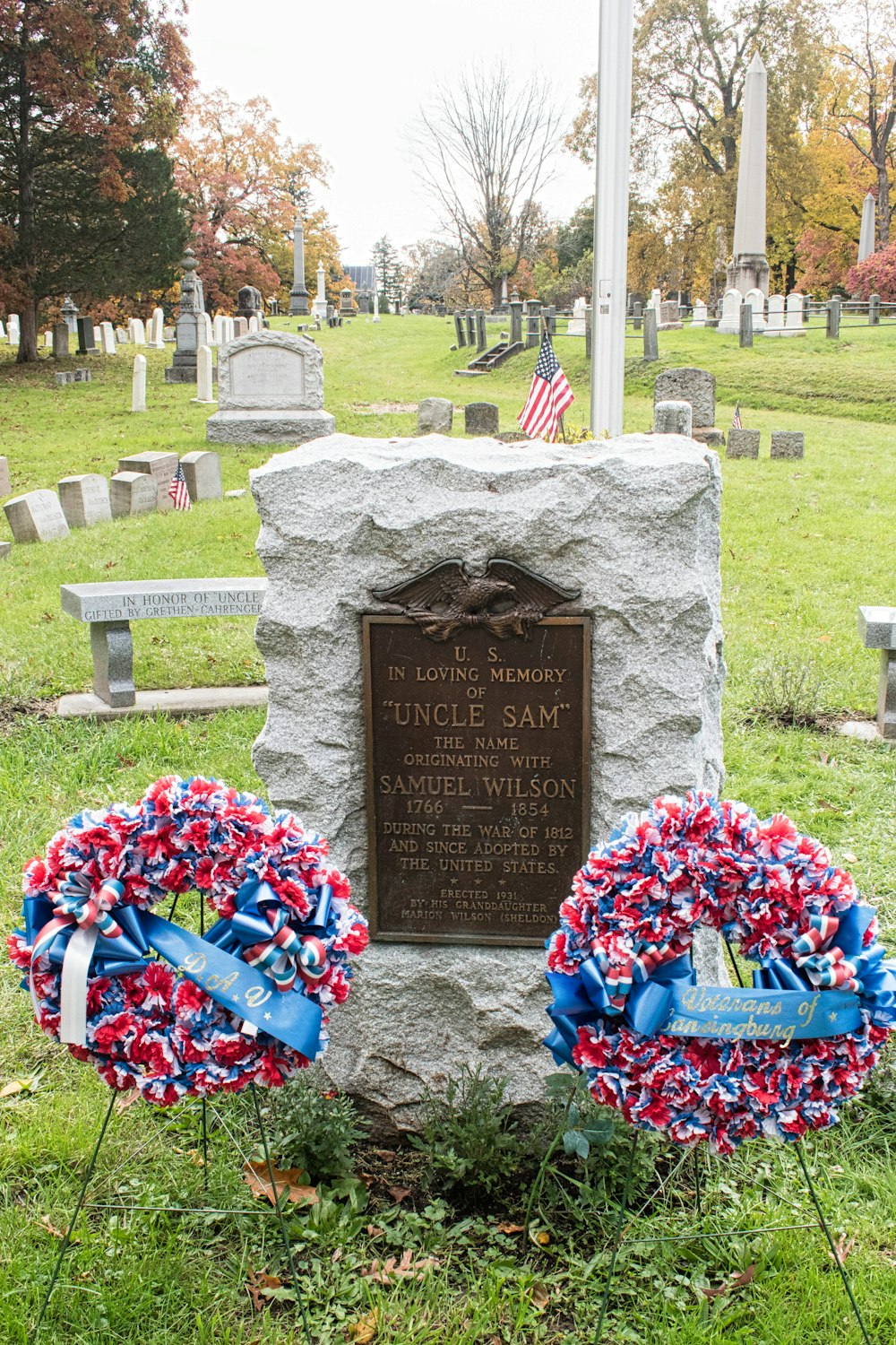 two wreaths are placed in front of a grave