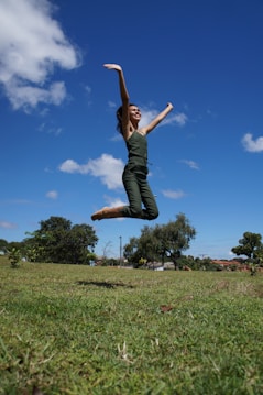 a woman jumping in the air with a frisbee