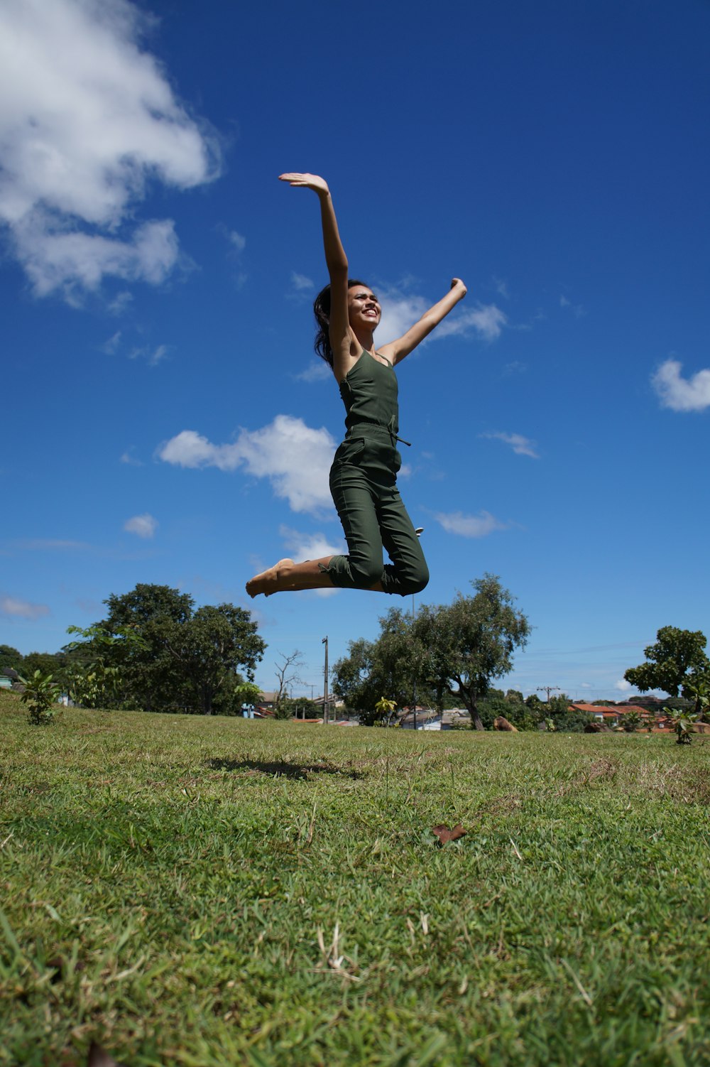 a woman jumping in the air with a frisbee