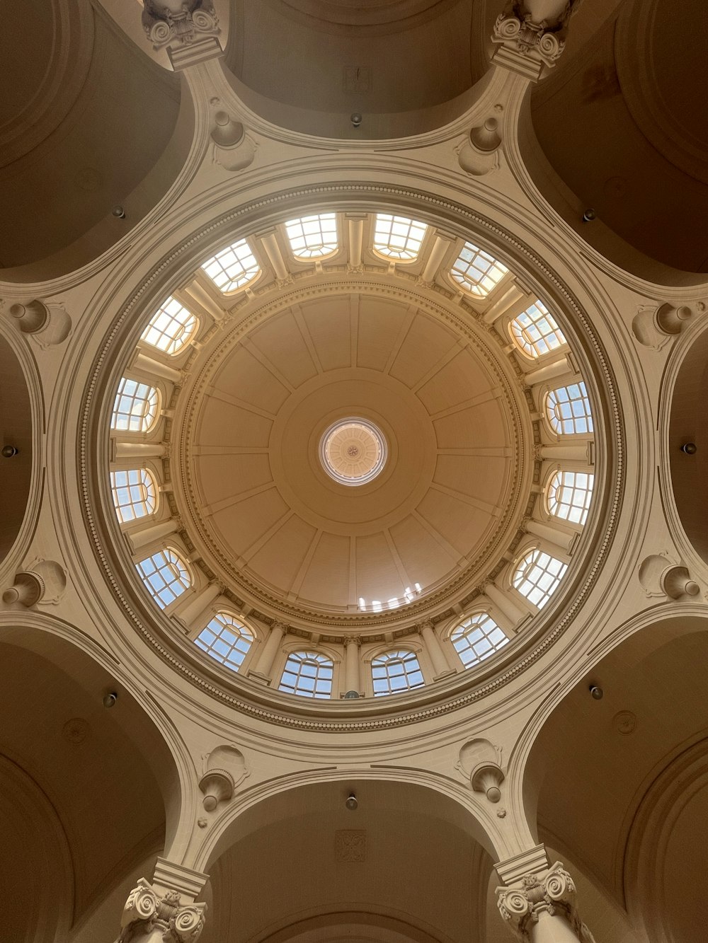 the ceiling of a building with a circular window