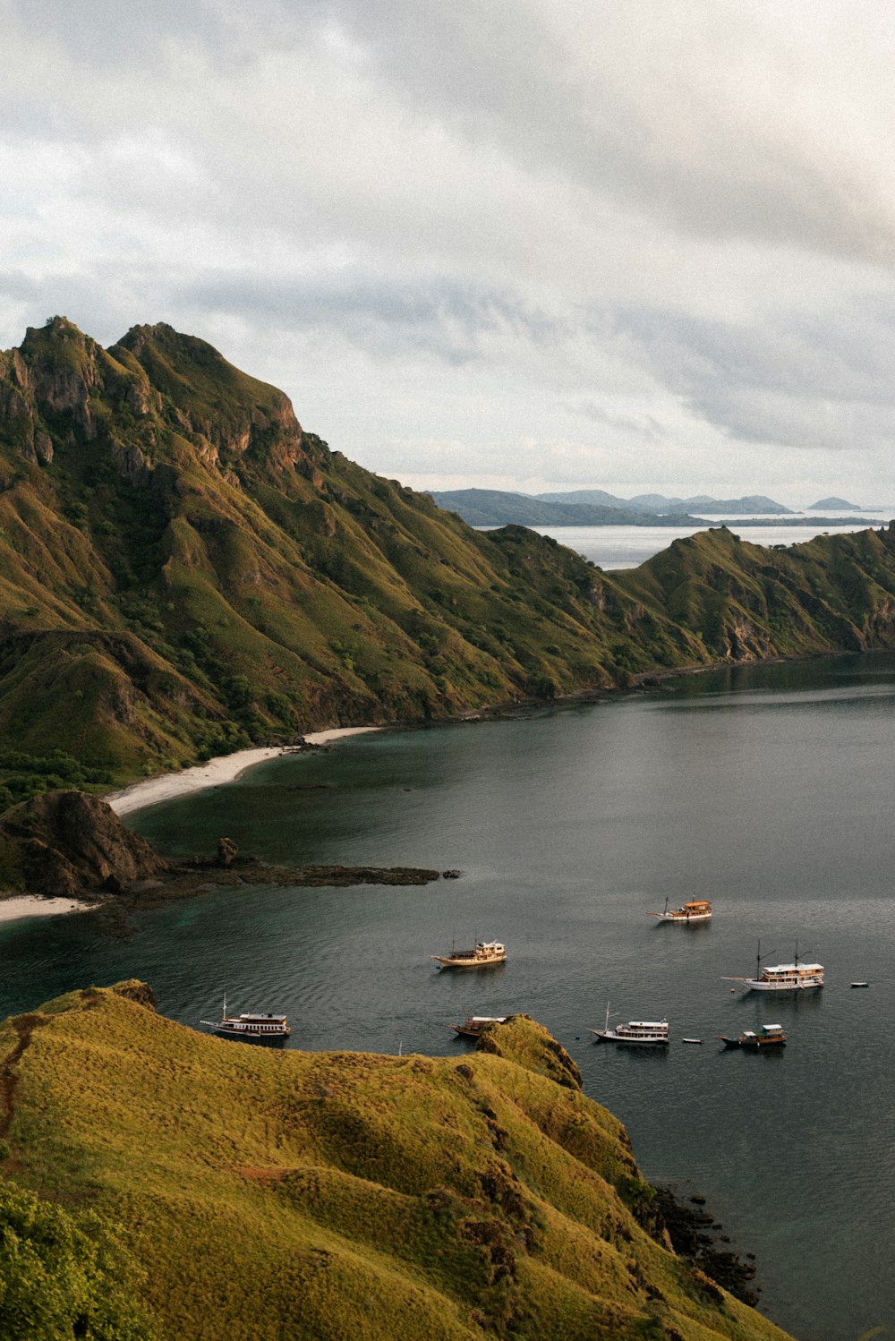 a group of boats floating on top of a large body of water