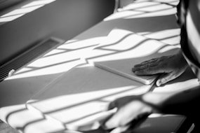 a person sitting at a table with a book