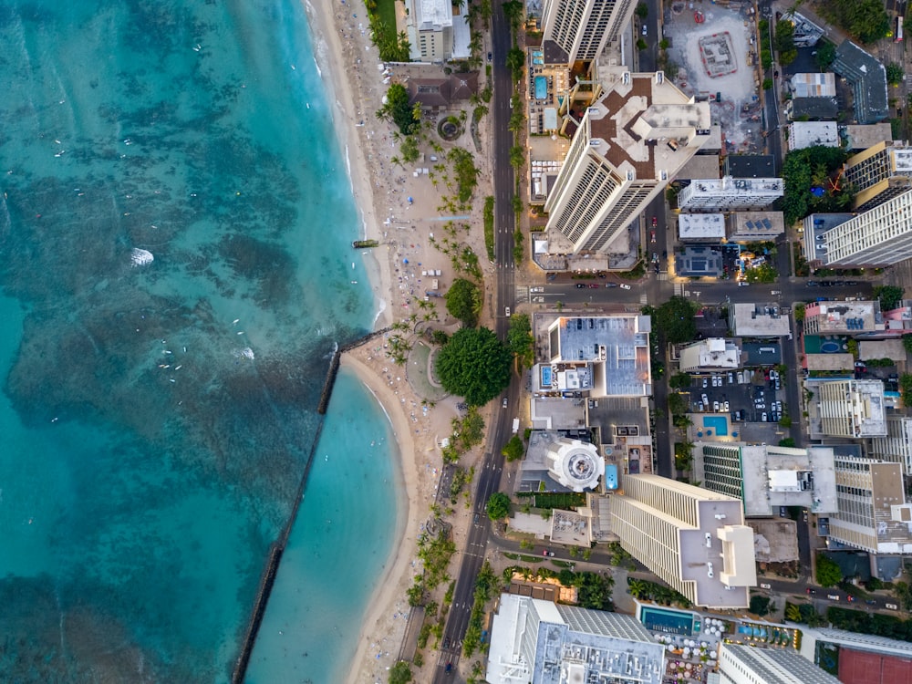 an aerial view of a city next to the ocean