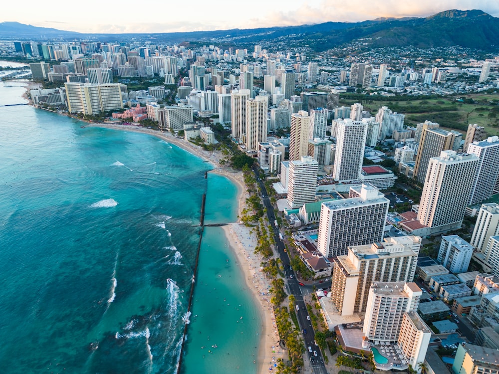 an aerial view of a city next to the ocean