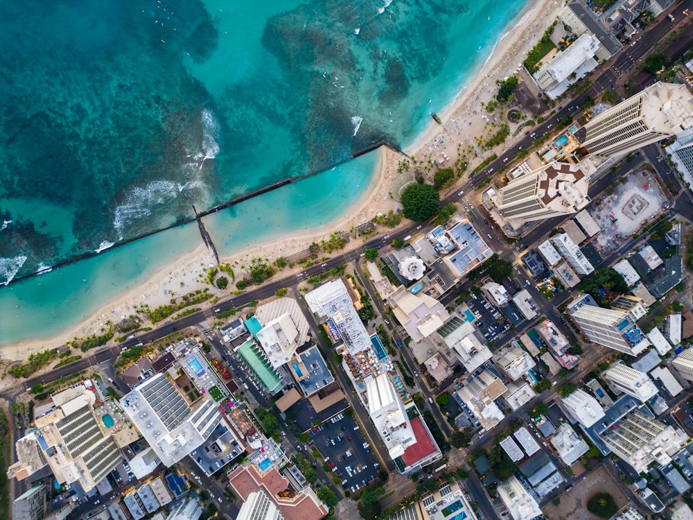 an aerial view of a city next to the ocean