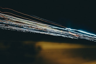 Abstract high-speed motion blur lines crossing over a slate gray backdrop, symbolizing rapid movement and energy.