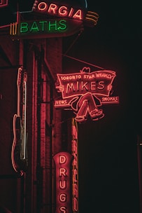 A vibrant neon sign glowing in a dark urban setting.