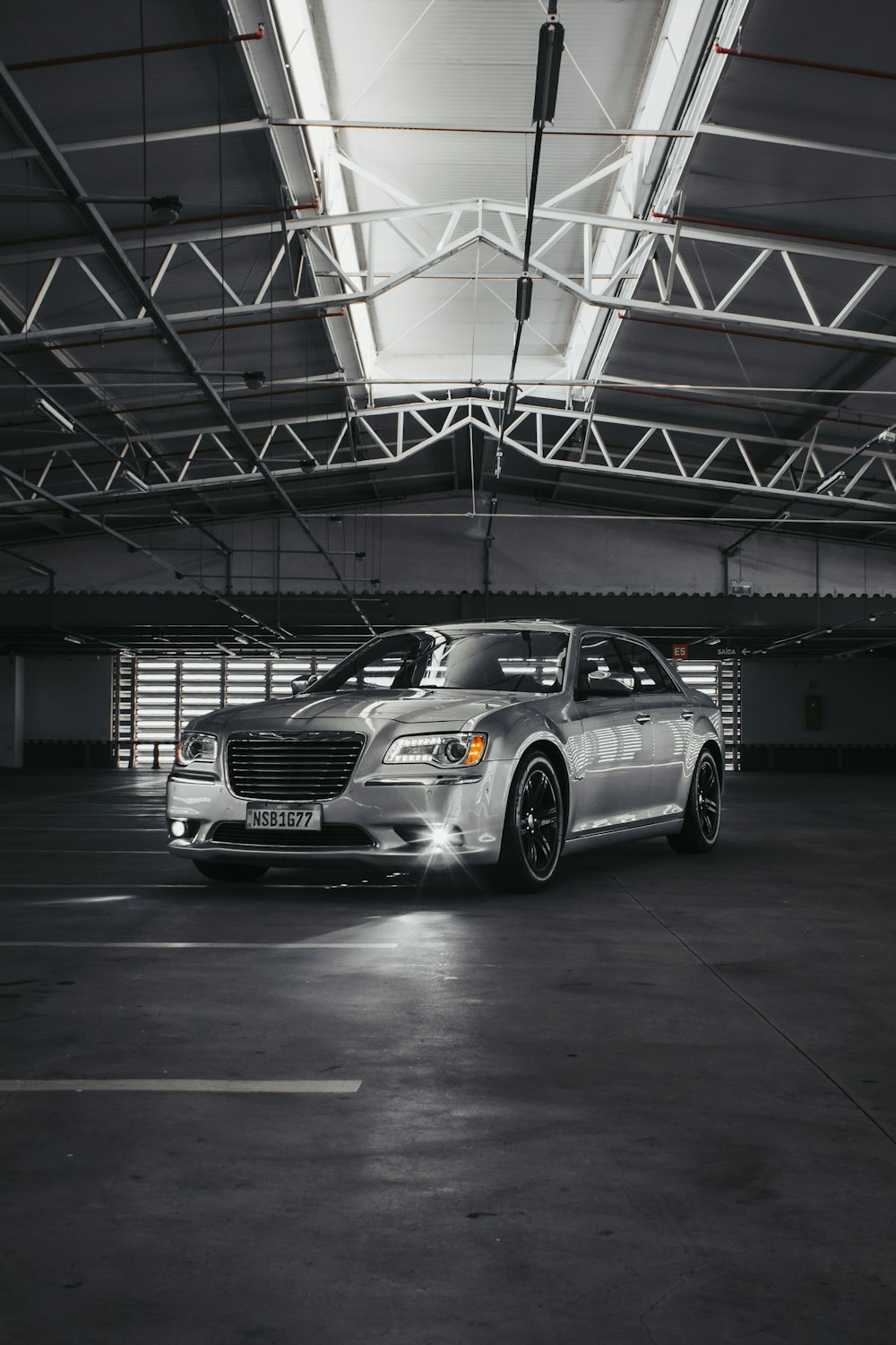 a silver car parked in a parking garage