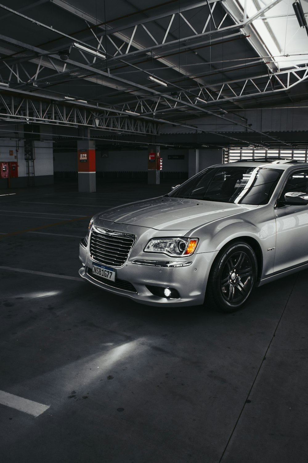 a silver car parked in a parking garage