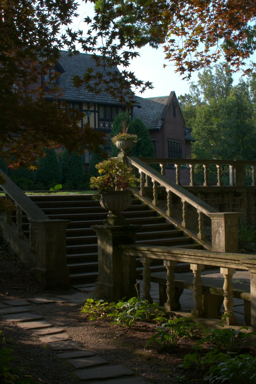 a stone walkway leading to a large house