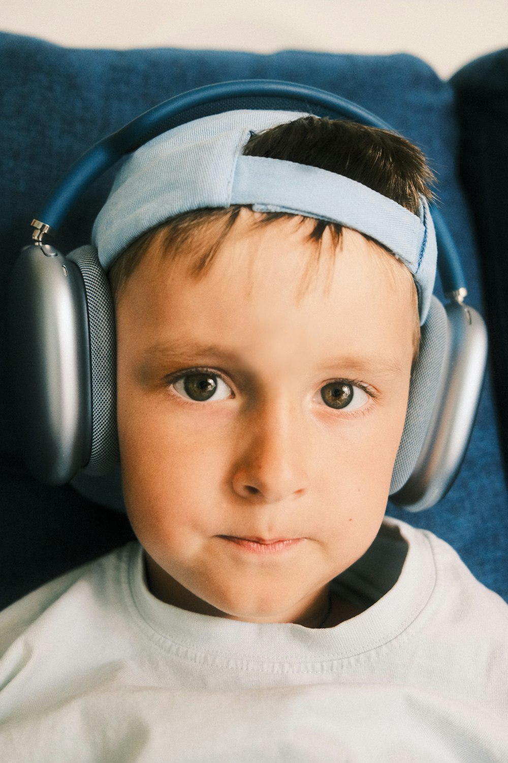 a young boy wearing headphones on top of his head