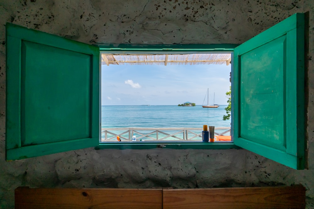 an open window with a view of the ocean