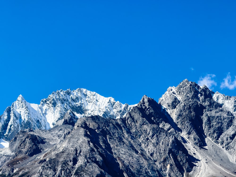 a mountain range with snow capped mountains in the background