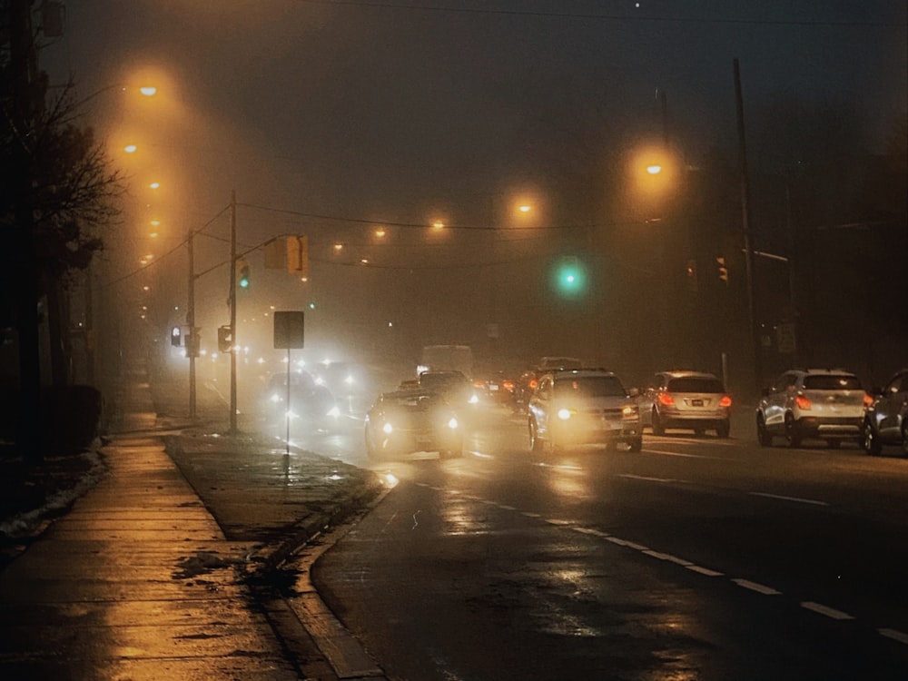 a city street filled with lots of traffic at night