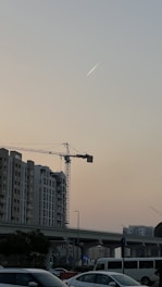 A service truck parked at a busy job site with contractors actively working under a city skyline at dusk.
