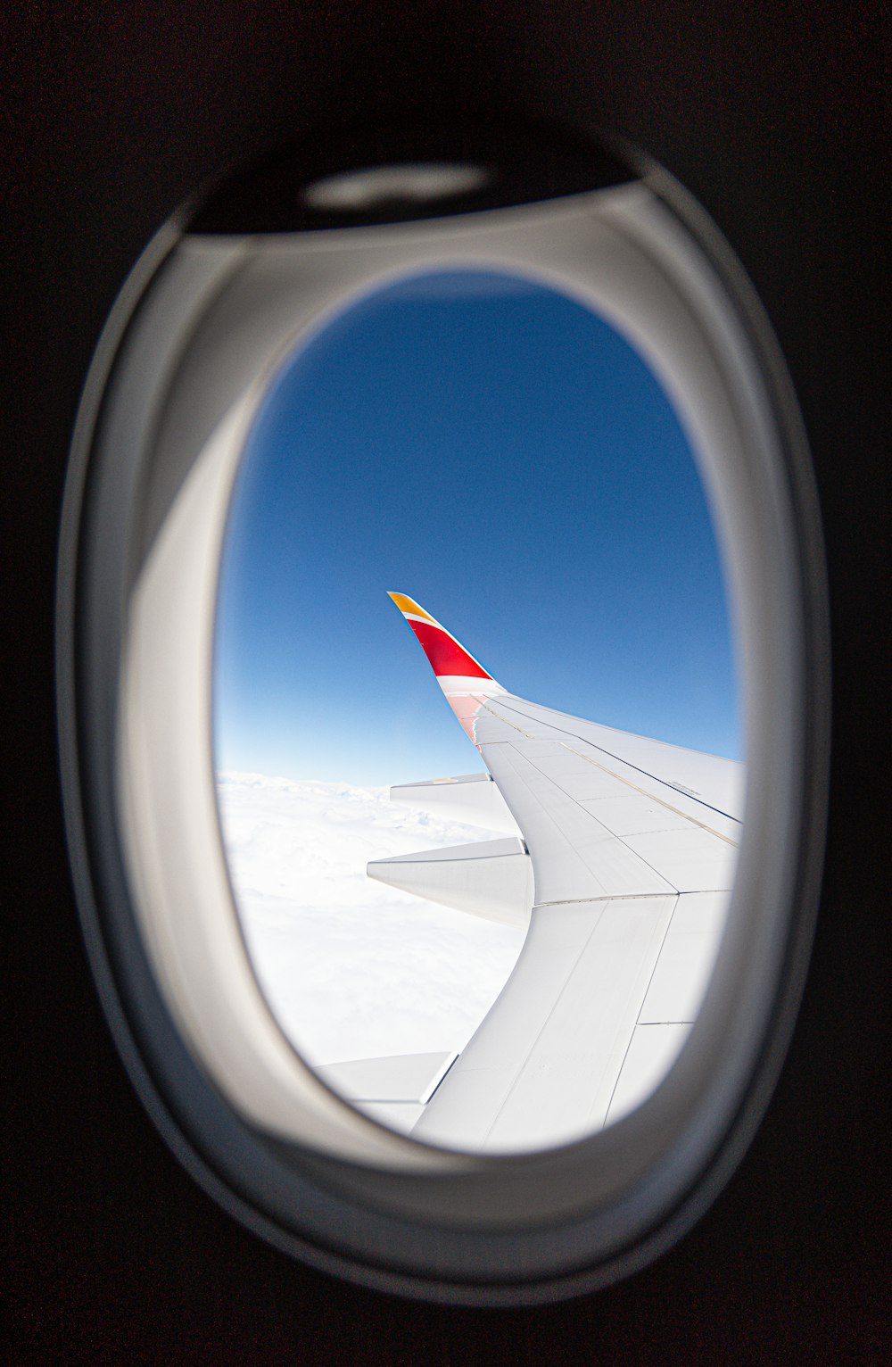 a view of the wing of an airplane through a window