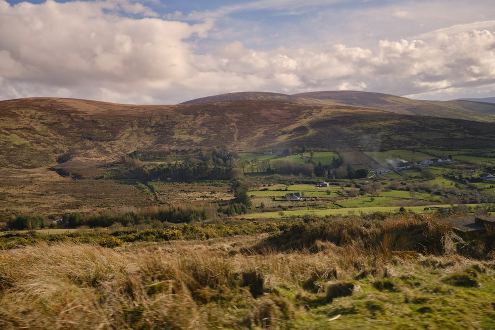 a view of a valley with a few hills in the background