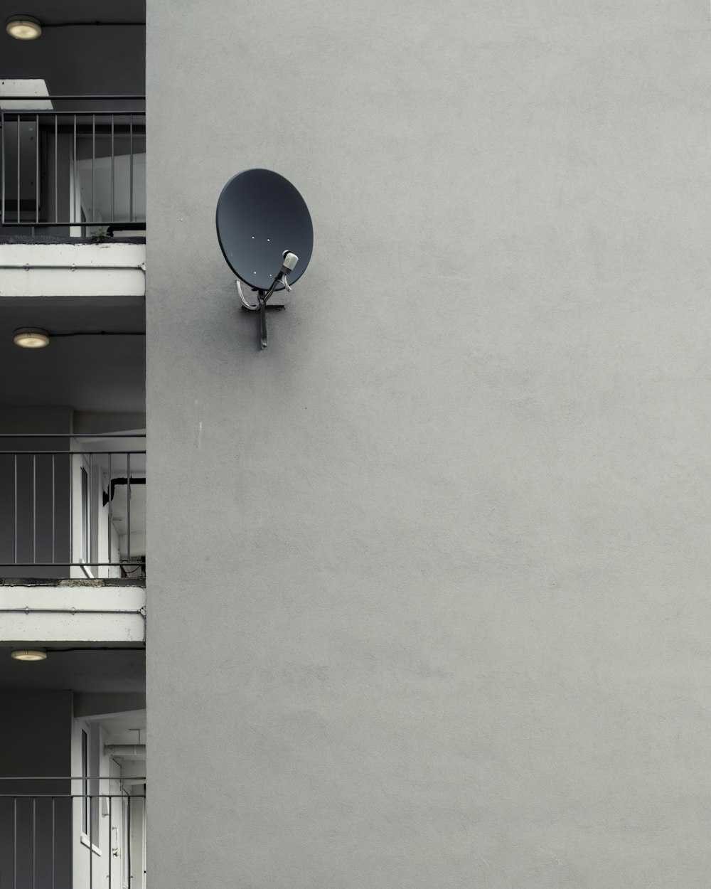 a satellite dish mounted to the side of a building